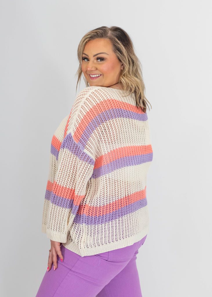 cream open knit sweater with orange/purple stripes