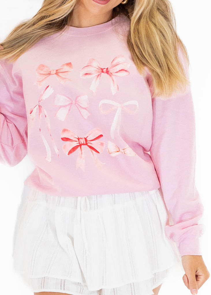 pink crewneck with bow graphic