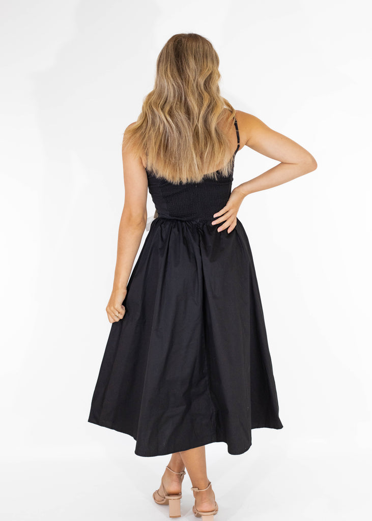 black midi dress with white bow details on front