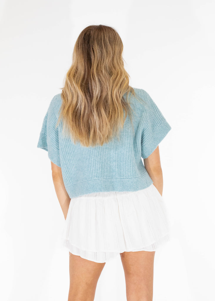 light blue sweater top with pearls